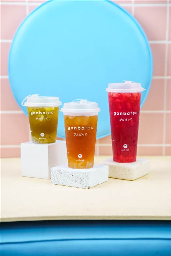 Three tea cups on white blocks against a blue and pink set, Ganbatea