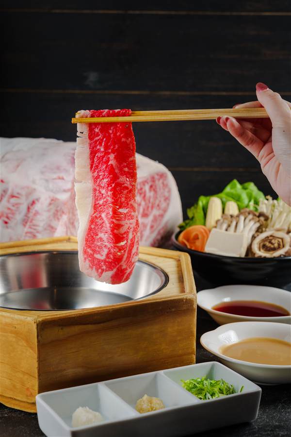 Wagyu slice lifted with chopsticks over a shabu pot, Hotaru Shabu2